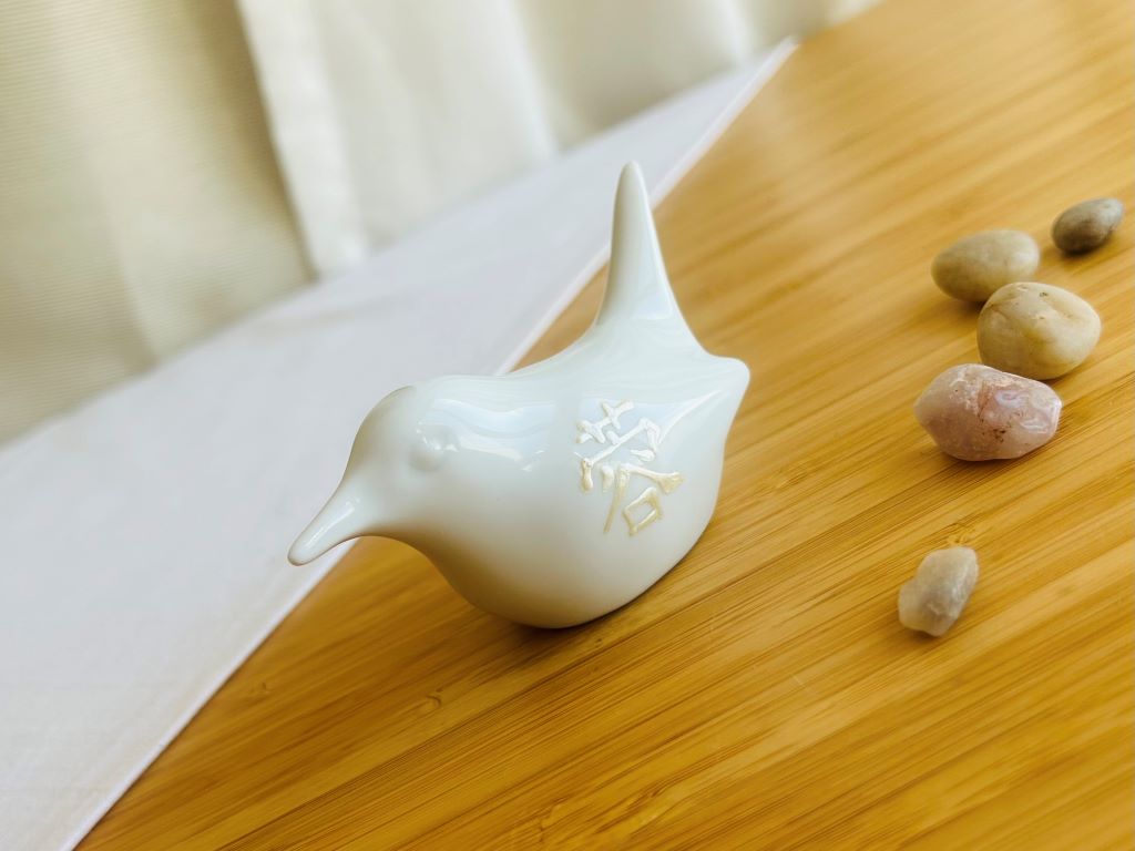 porcelain bird with various Japanese garden motifs
